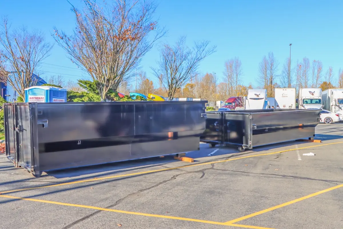 Professional dumpster rental service with roll-off container on residential driveway in Kingsville